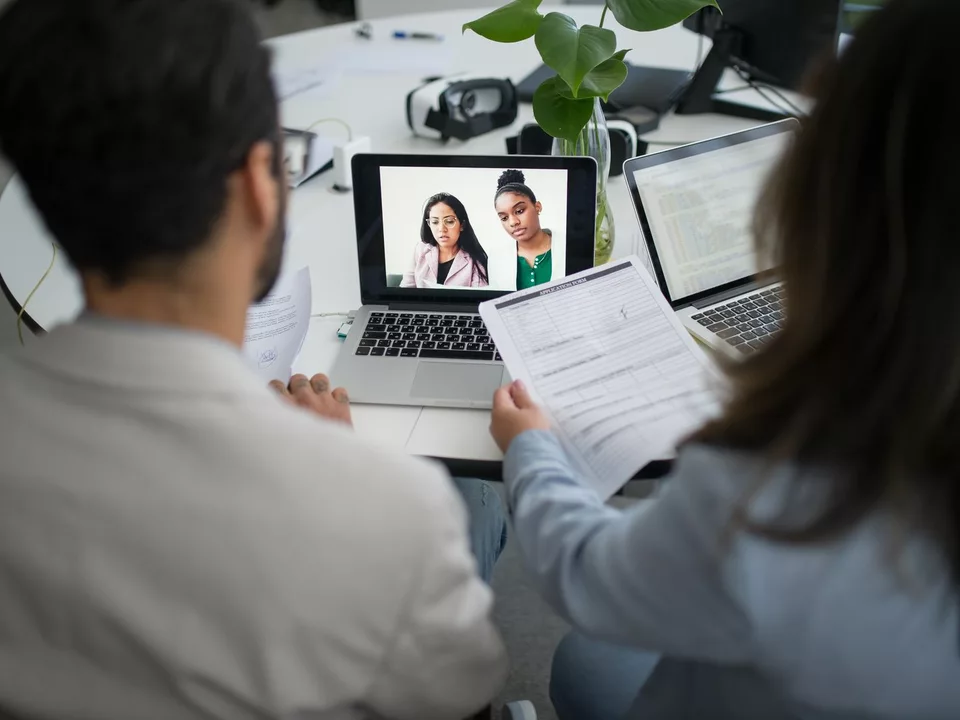 Professionals conducting a remote job interview